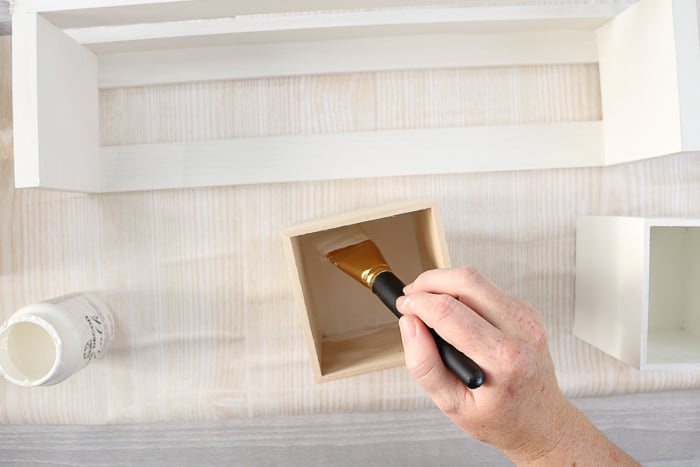 woman painting wood box white