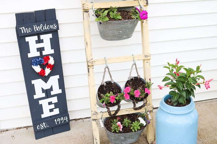 My home sign has a patriotic red, white, and blue wreath for the summer season