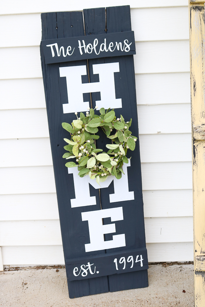 A simple farmhouse style wreath on my DIY home sign is perfect for all seasons