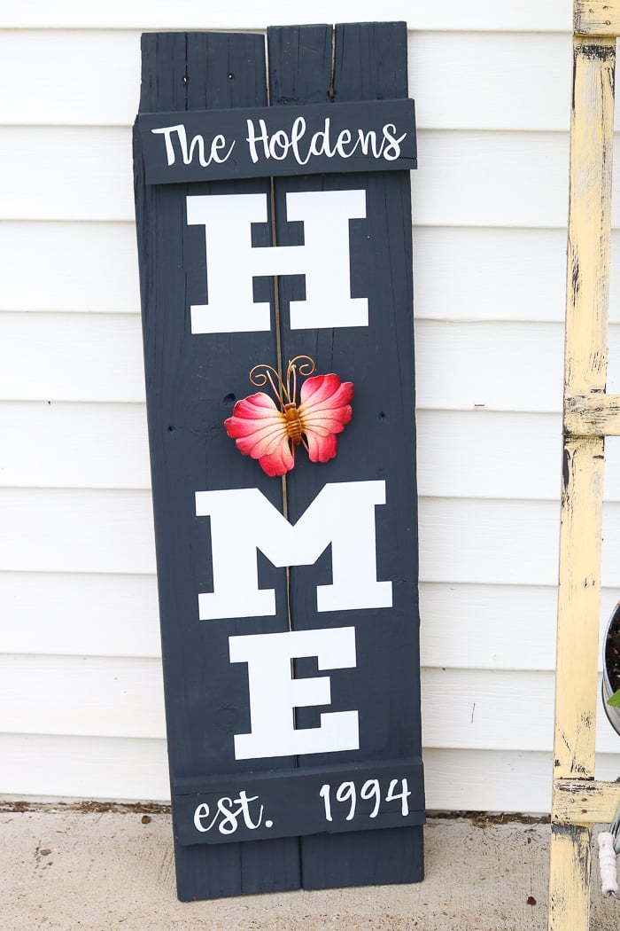 My DIY wood home sign with a metal butterfly garden ornament instead of a wreath for the O