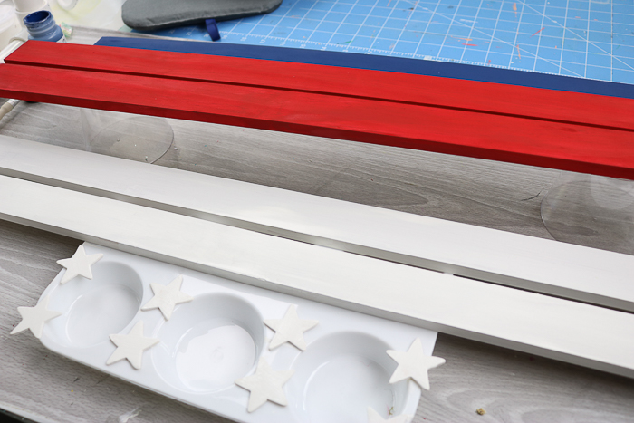 Paint the wooden slats red, white, and blue. Then attach the white stars