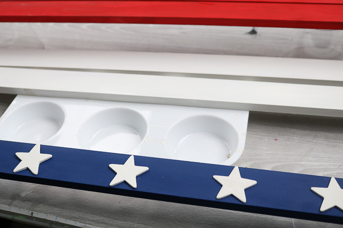 Add the white stars to the blue slat of your patriotic wood star