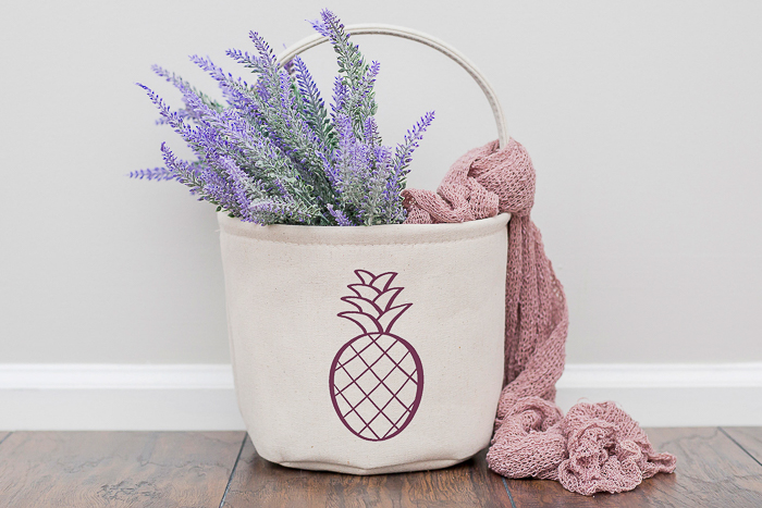 canvas basket using my free pineapple cut file holding flowers with a blanket spilling out