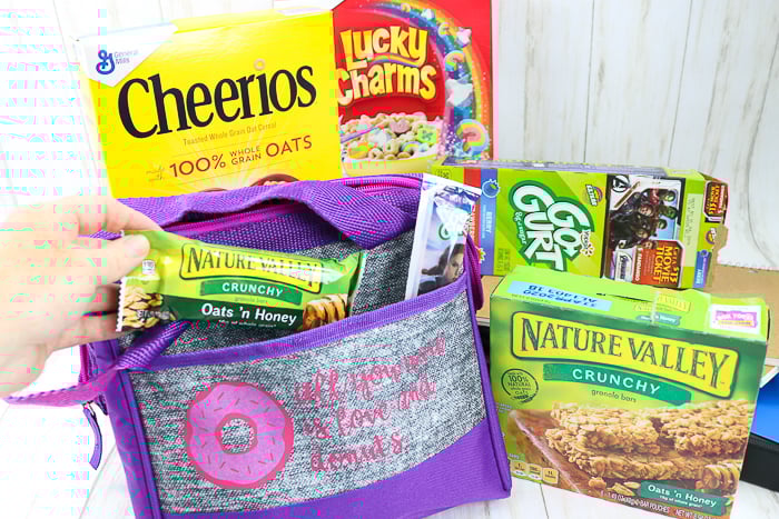 putting granola bar into a custom DIY lunch box