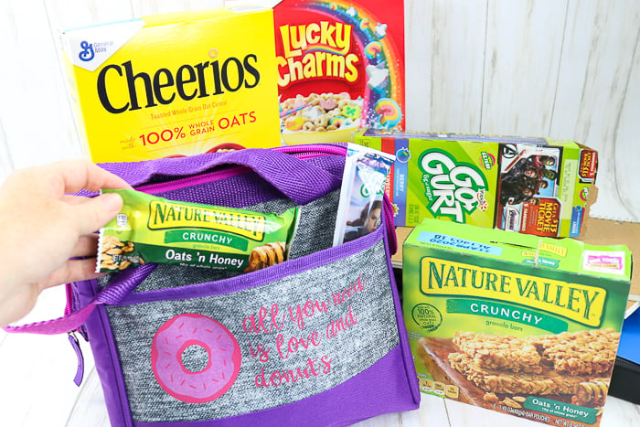 putting granola bar into a custom DIY lunch box