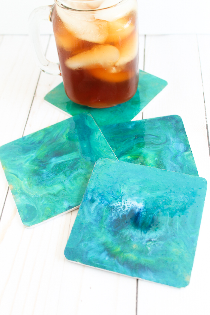 applying marbled resin to coasters