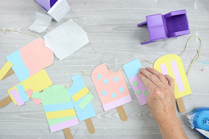 adding decorations to paper popsicles