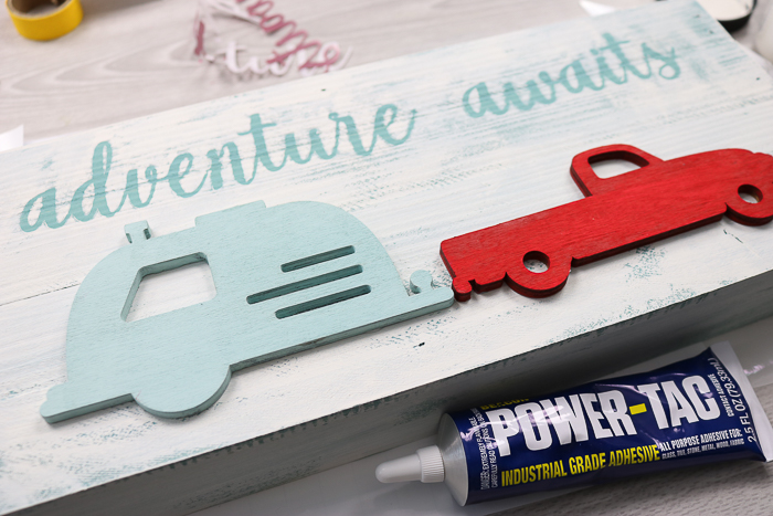 gluing wood truck and camper to wood sign
