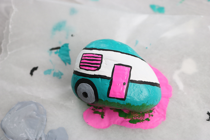 Added painted wheels and accents to this camper painted rock