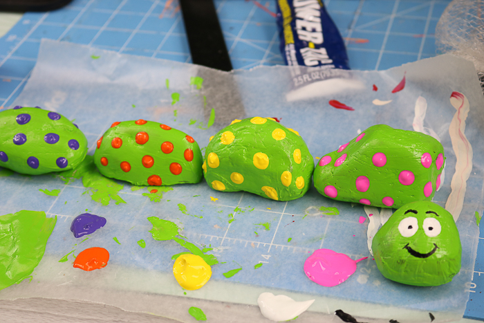 adding painted polka dots to rocks