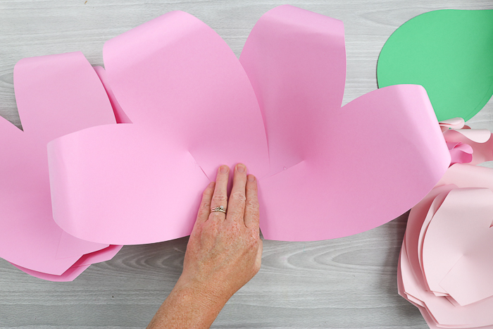 Start assembling your large paper flowers by layering the larger flower petals on top of each other and hot gluing them together