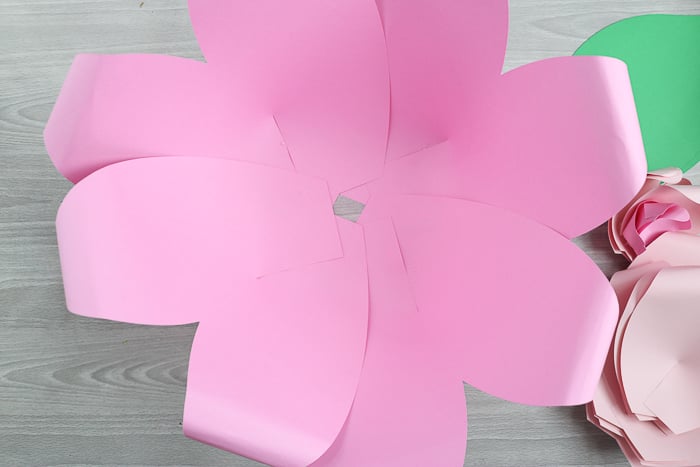 Use the largest paper flower petals to create the outside layer of the flower