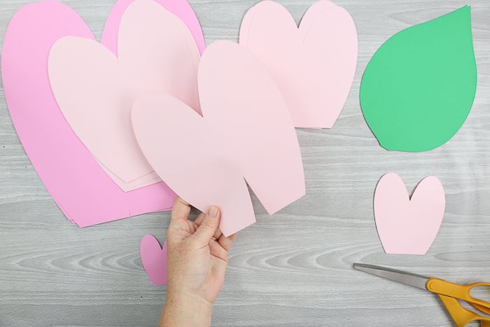 Cut slits into the paper flower petals in order to arrange them around the flower center.