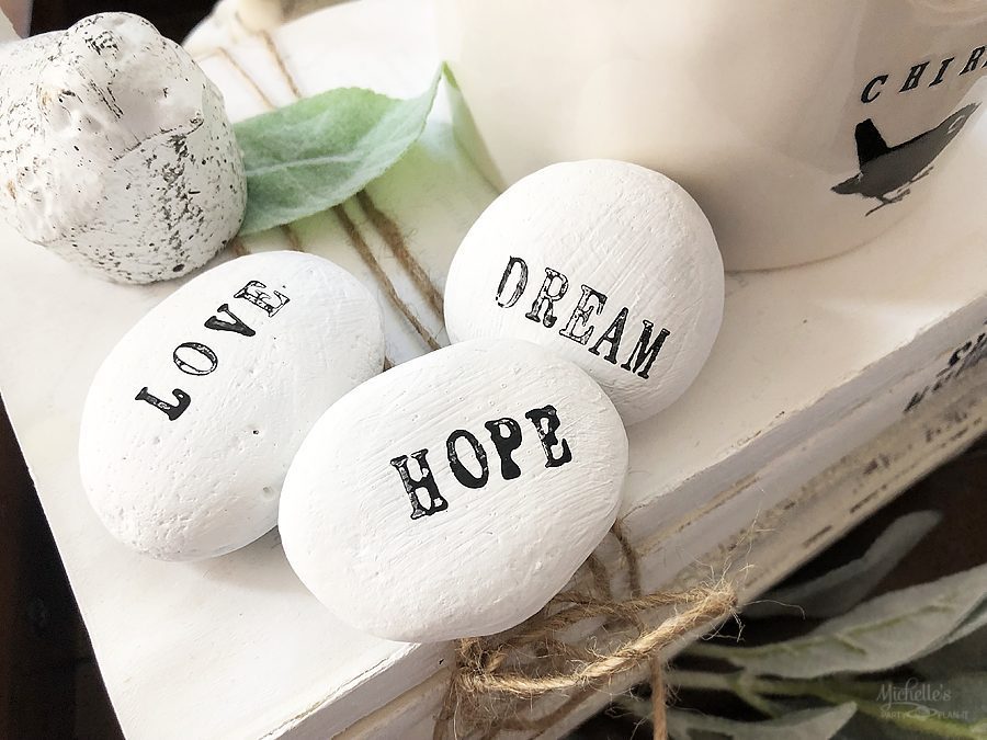 stamped painted rocks that say love, hope, and dream