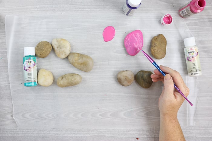 adding paint to rocks