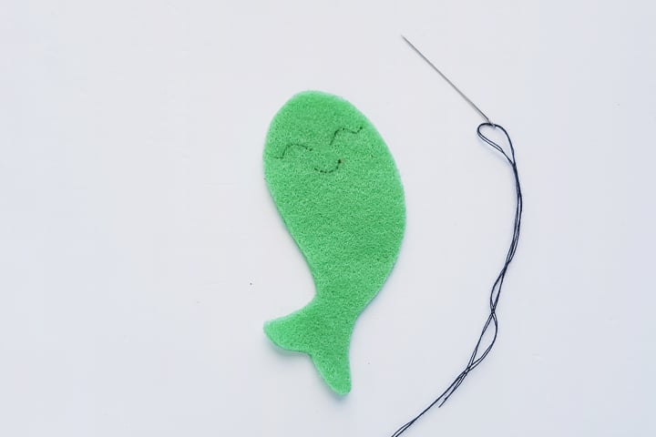 smiley face on cut felt narwhal