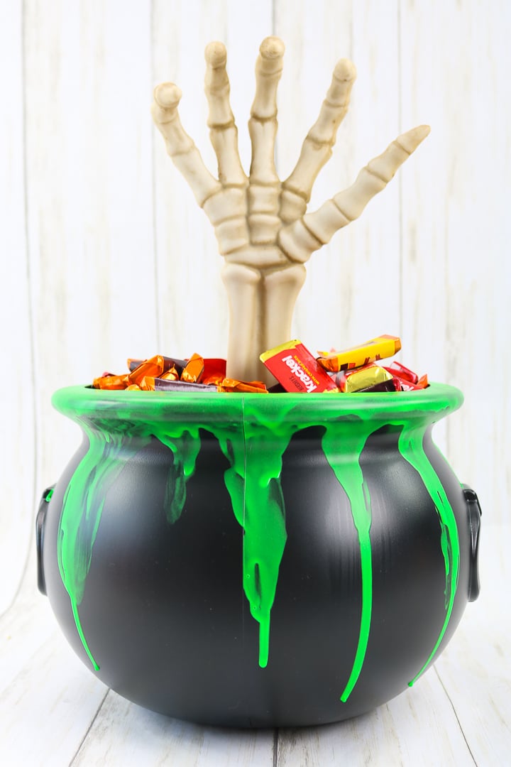 spooky hand in a halloween candy bucket