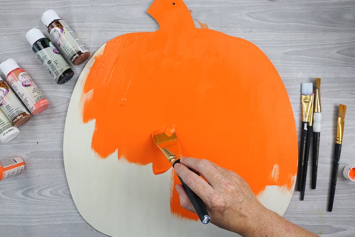 painting a pumpkin orange