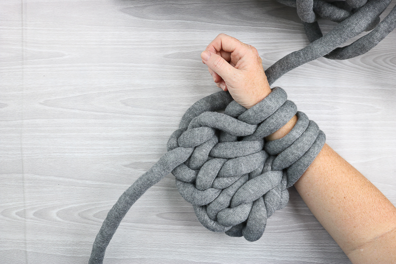 grey yarn knitted by arms