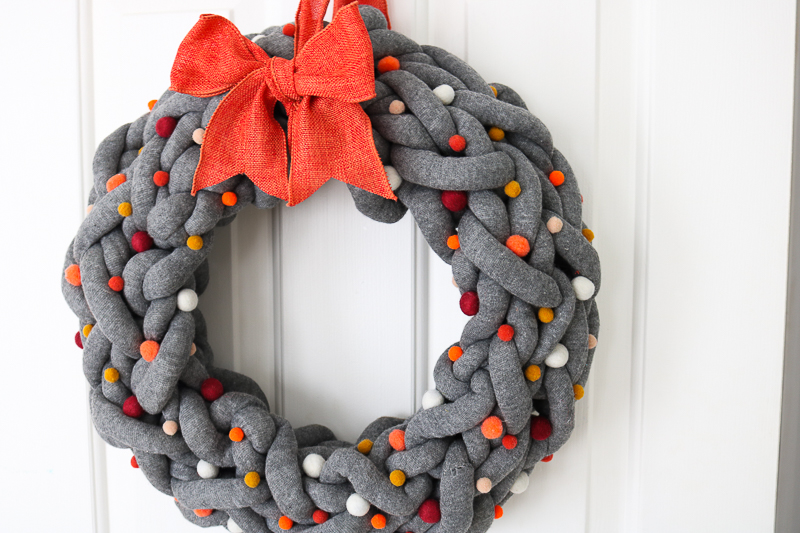 diy autumn wreath with yarn on door 