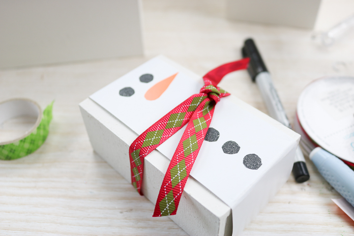 adding ribbon to a gift box