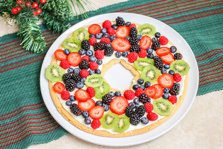 A bowl of fruit on a plate, with Cookie and Sugar