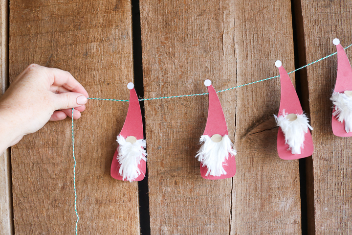 Best Christmas Paper Crafts featured by top Seattle lifestyle blogger, Marcie in Mommyland: These adorable little Christmas gnomes make the cutest Christmas banner!
