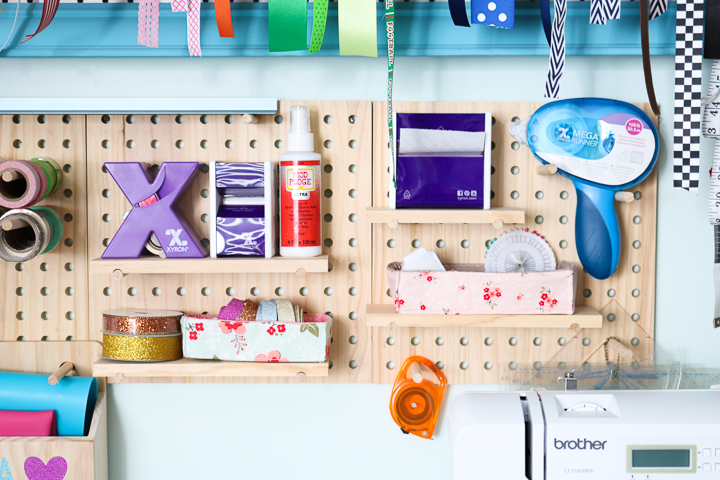 Using craft room pegboards is a great way to easily organize all your craft supplies in once space.