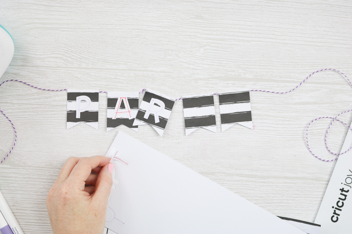 Apply cut out letter pieces drawn with Joy pens to banner pieces