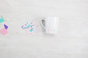 adding sprinkles on a coffee mug