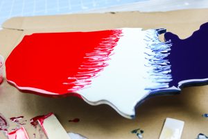 swirling red, white, and blue resin on wood