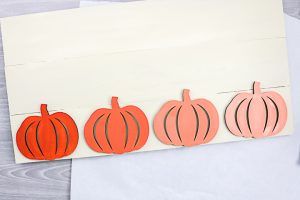 wood pumpkins on a sign