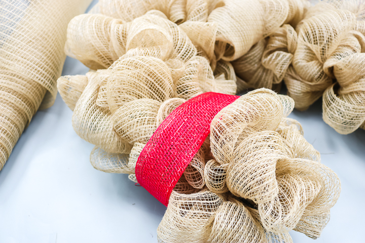 adding reindeer details to a holiday wreath