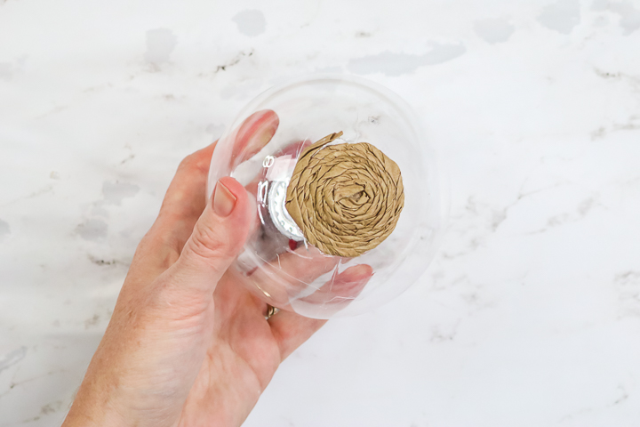 using hot glue to secure kraft paper to ornament