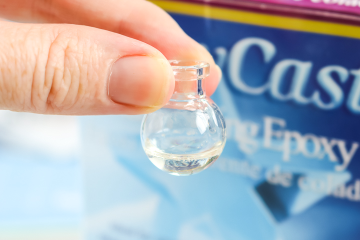 adding mixed resin to a glass globe