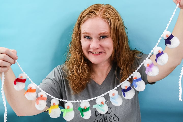 Angie Holden craft blogger holding a snowman garland