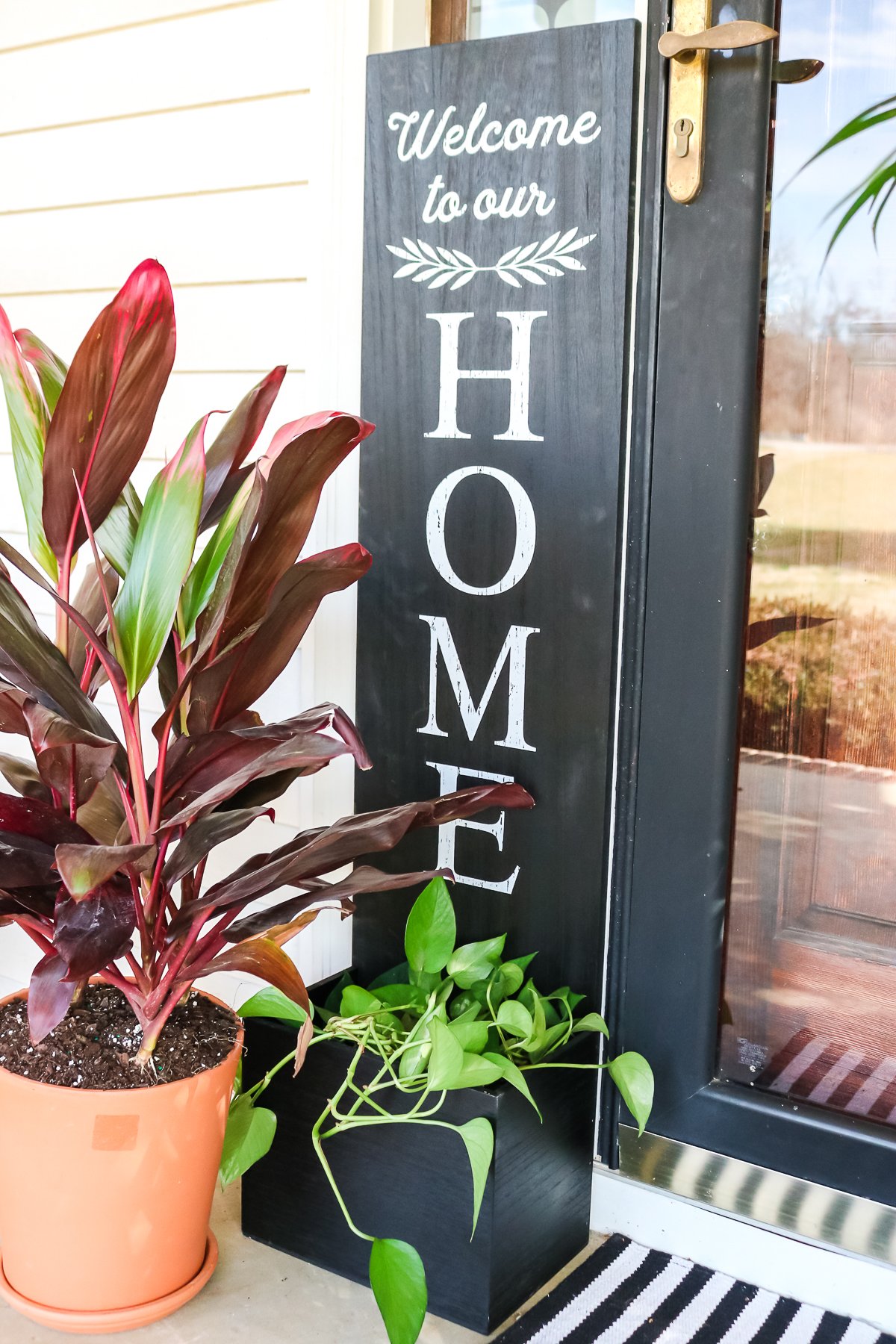 welcome sign with a planter box