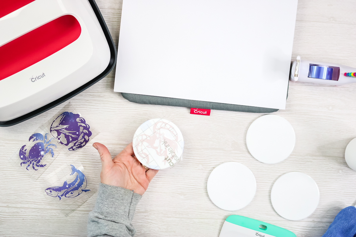 putting infusible ink down on the front of a ceramic coaster