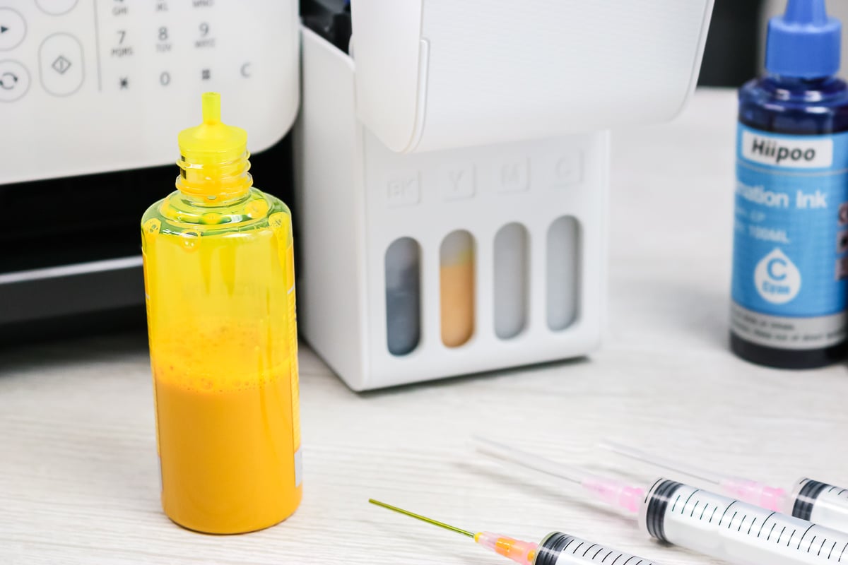 bottle of yellow sublimation ink on a table