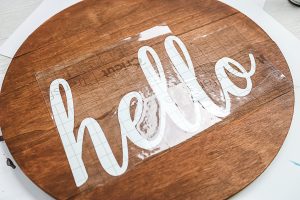 using transfer tape to move vinyl cut into the word hello