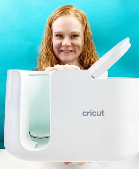 angie holden holding the cricut mug press