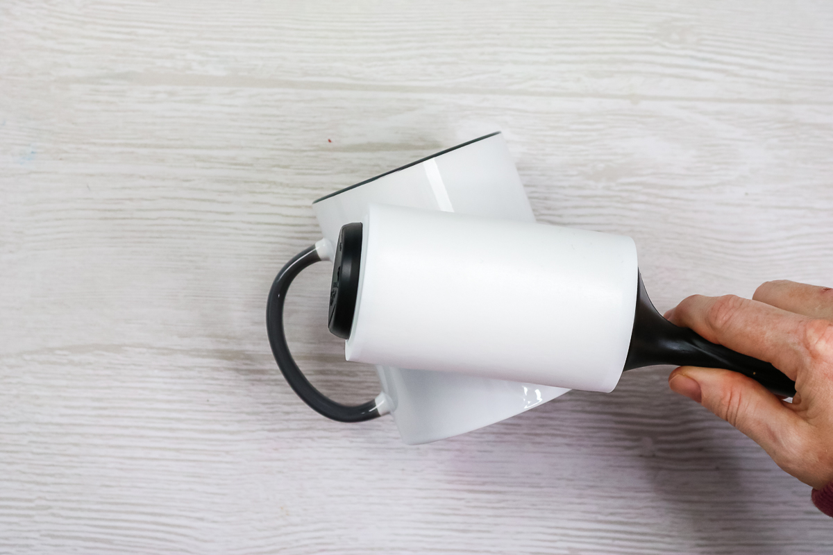 cleaning a mug with a lint roller