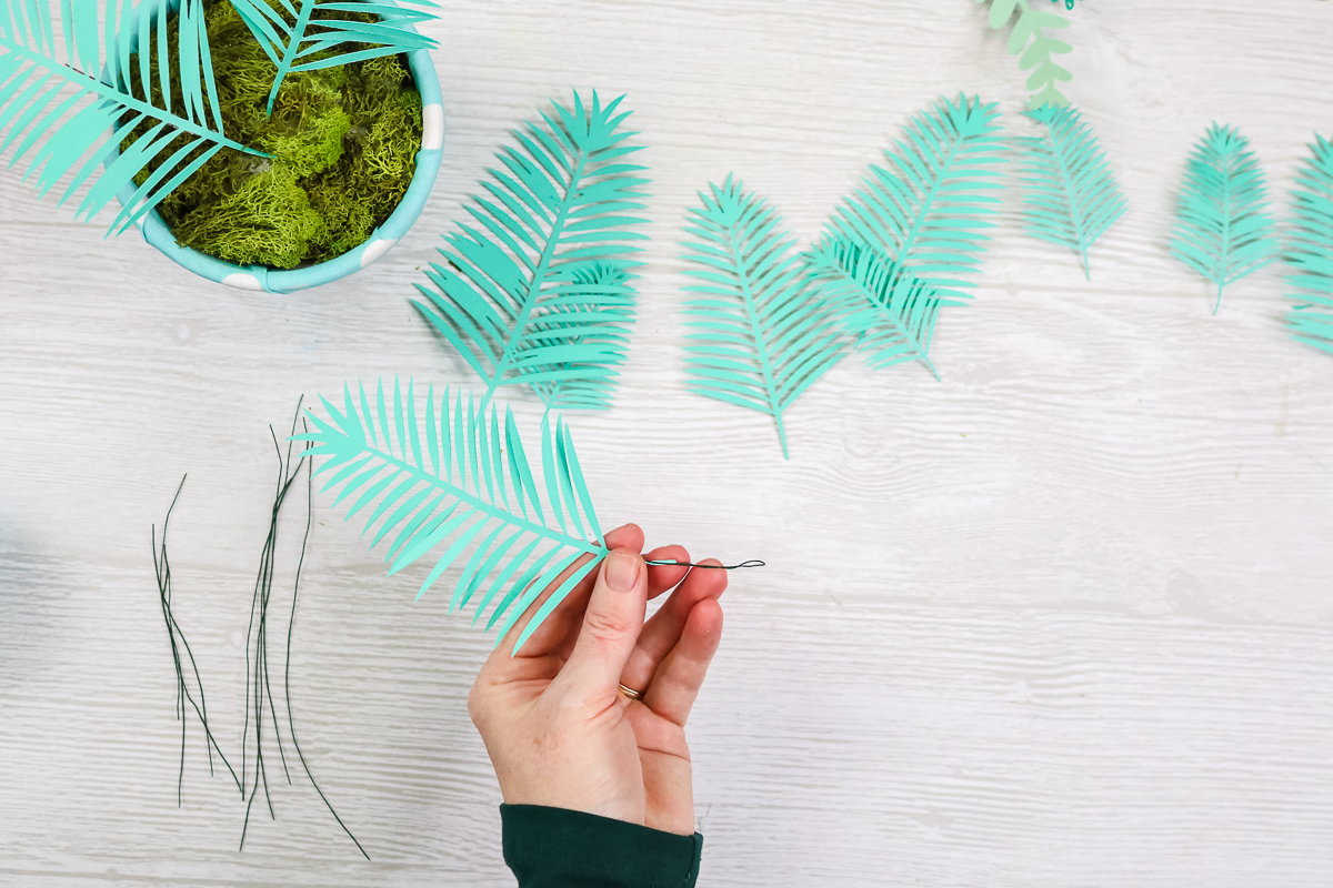 folding wire end over on plant leaves made from paper