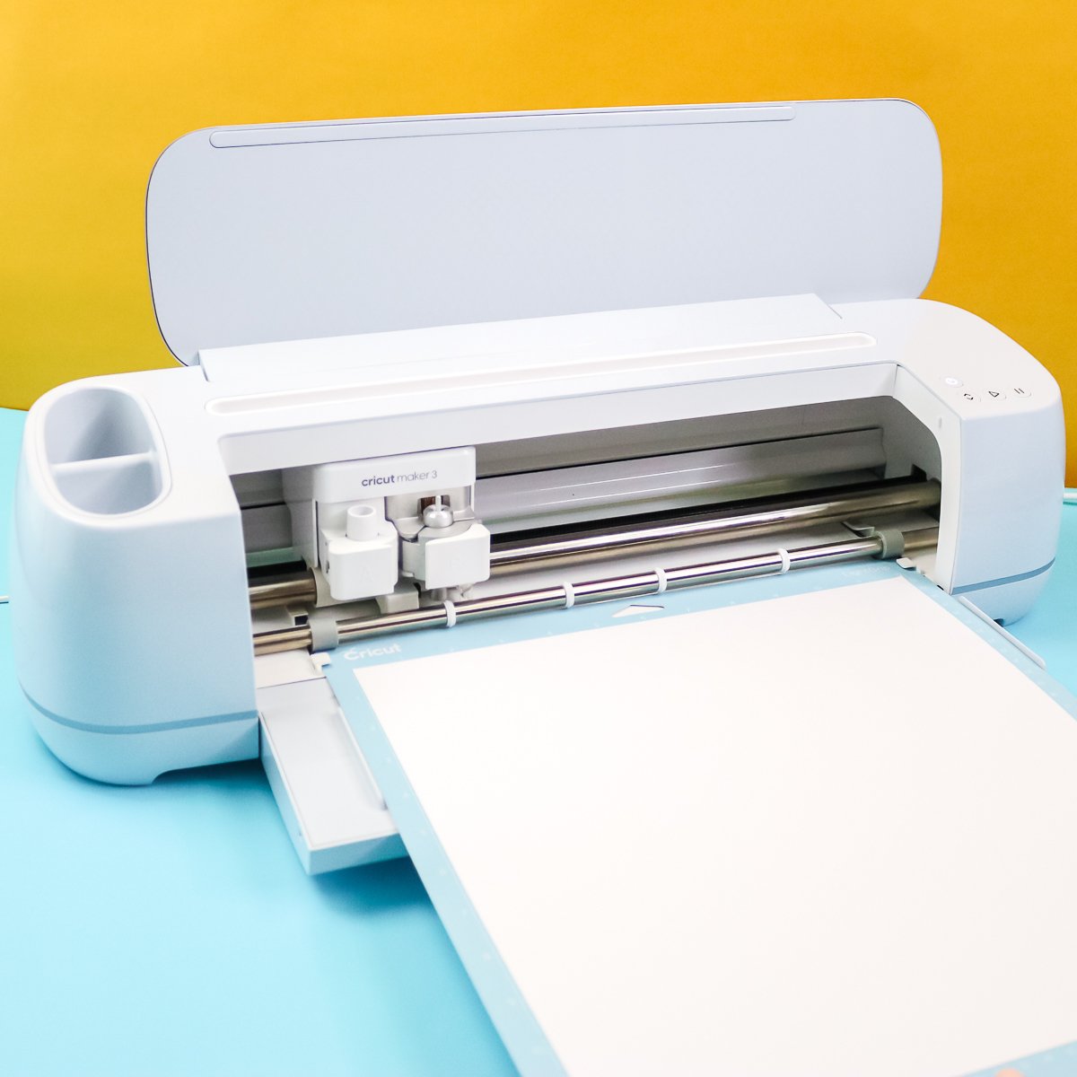 cricut maker 3 cutting material on a mat