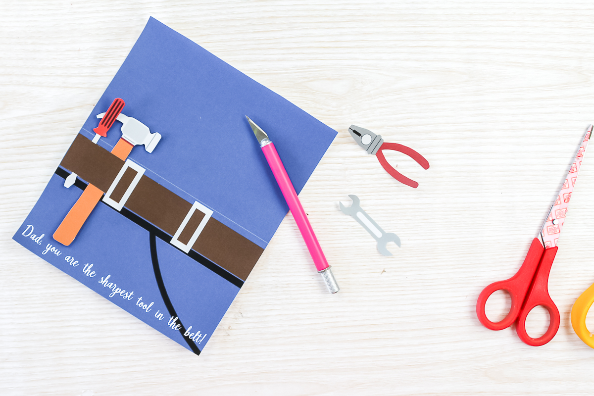 using a knife to put holes in a father's day card