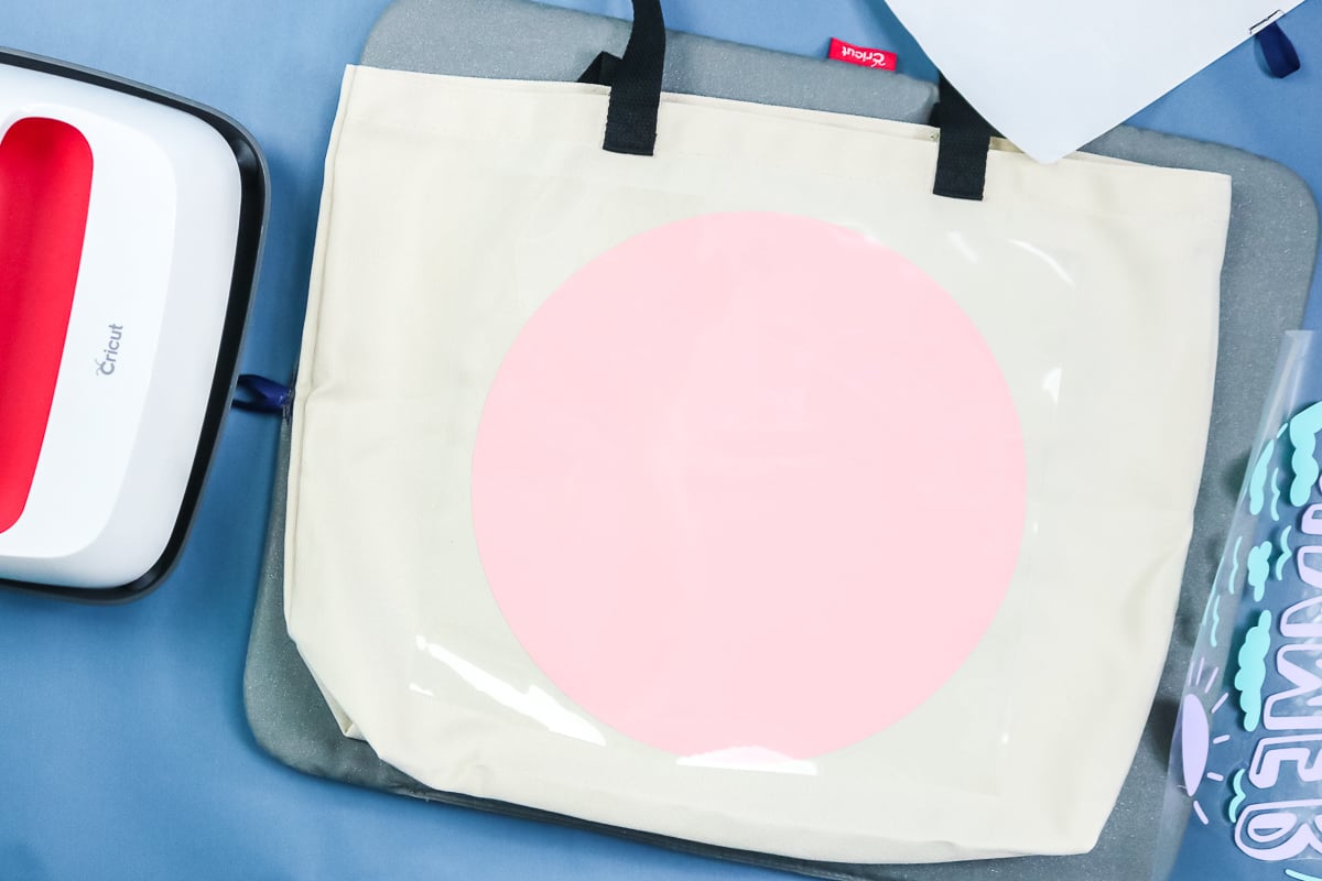 adding a pink circle of iron on to a tote bag