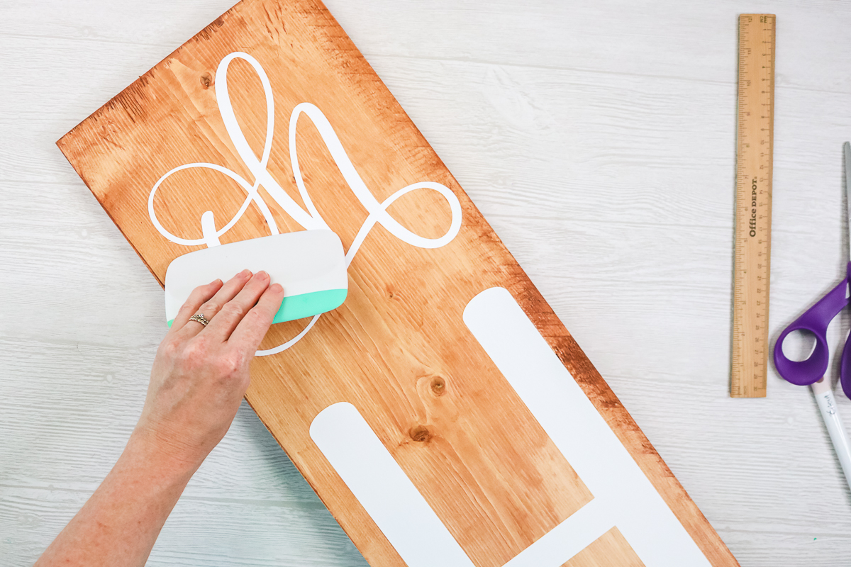 burnishing white vinyl on a wood sign