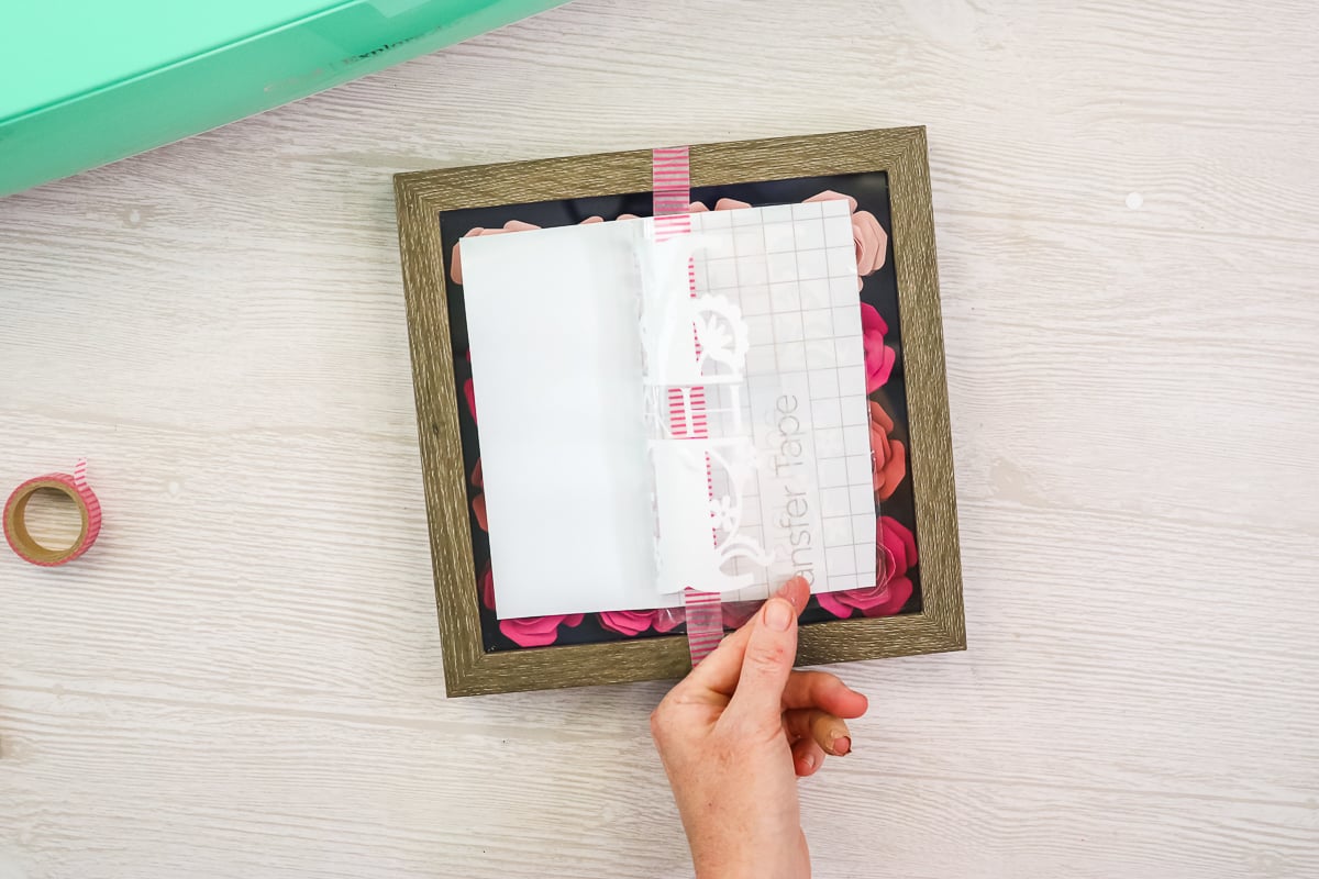 applying vinyl to the glass on a shadowbox