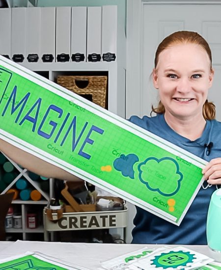 angie holden holding vinyl sign cut on a cricut