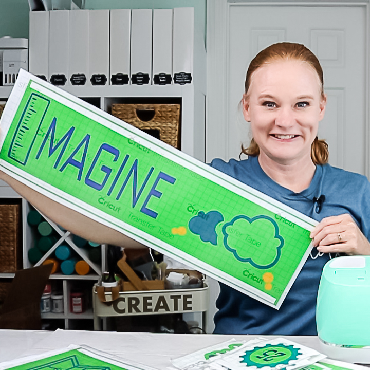 angie holden holding vinyl sign cut on a cricut